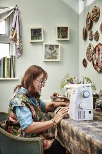 Textile artist Corinne Young at the sewing machine in her studio. Photo by Alun Callender for Country Living Magazine (September 2017).