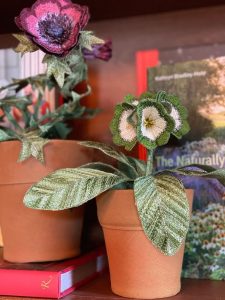Embroidered pot plant sculptures by textile artist Corinne Young on display in the Library Room, Lanesborough Hotel, London (May 2023).