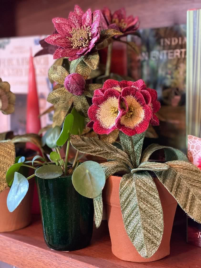 Embroidered pot plant sculptures by textile artist Corinne Young on display in the Library Room, Lanesborough Hotel, London (May 2023).