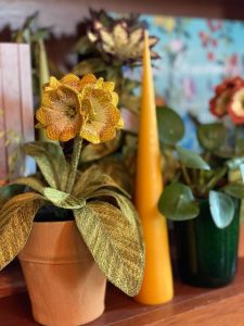 Embroidered pot plant sculptures by textile artist Corinne Young on display in the Library Room, Lanesborough Hotel, London (May 2023).