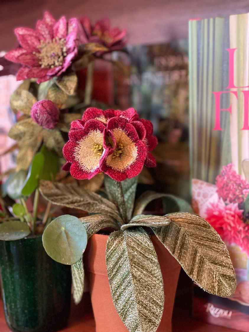 Embroidered pot plant sculptures by textile artist Corinne Young on display in the Library Room, Lanesborough Hotel, London (May 2023).