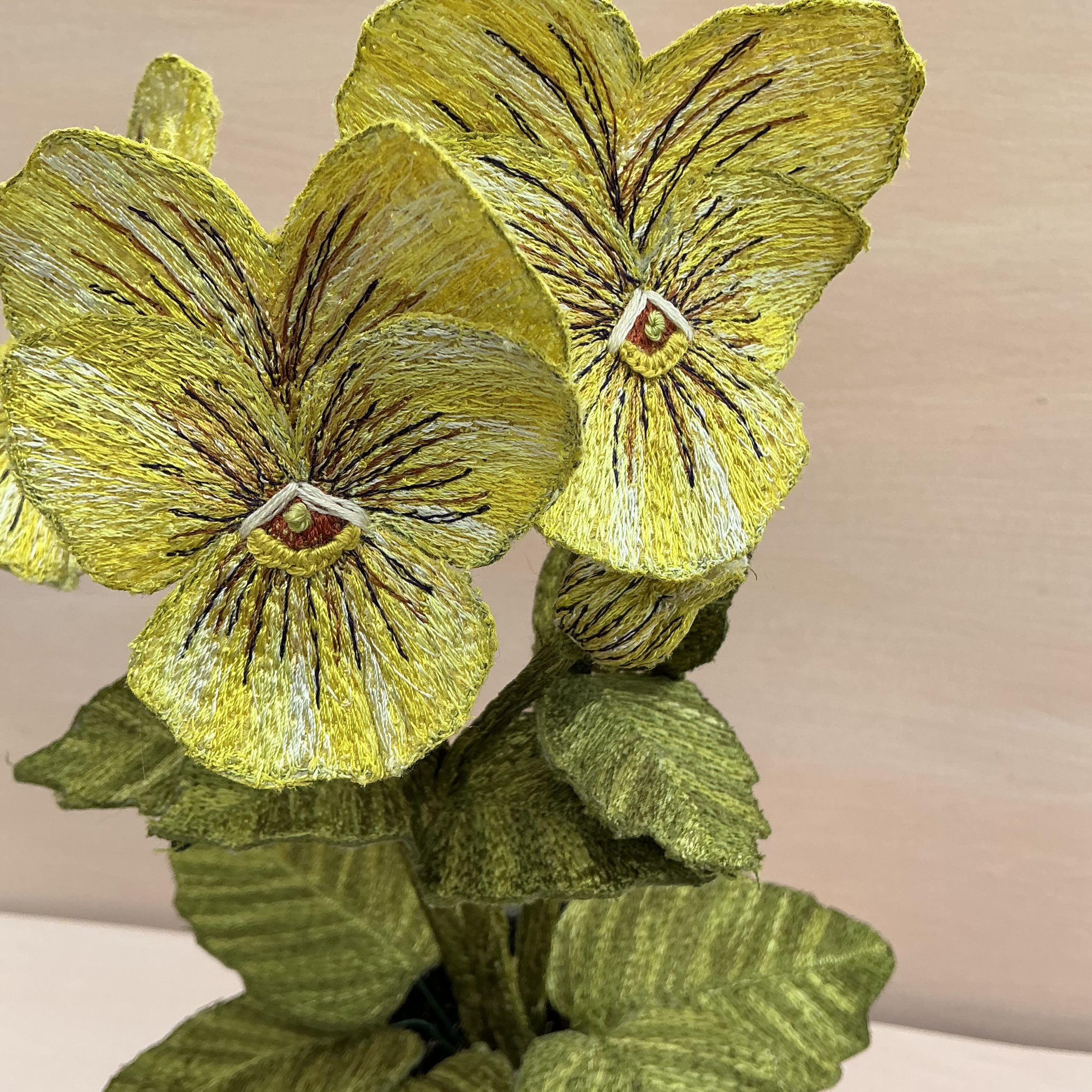 Yellow Pansy Embroidered Pot Plant (Detail) by Corinne Young for ROSA Botanical Art Fair 2026.
